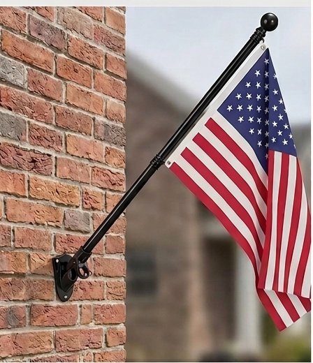 Flag pole kit mounted on brick flying an American flag